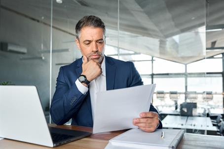 businessperson reading documents in an office