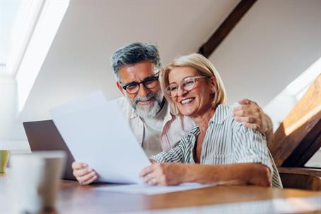 happy older couple reading documents